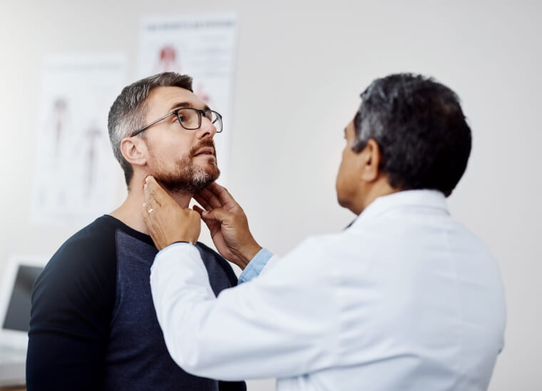 A doctor performing a wellness exam on a man