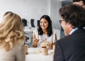 Coworkers eating lunch together