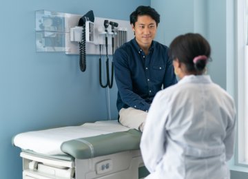 A male patient seeing a doctor for a wellness visit.